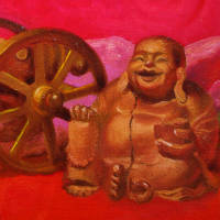 wooden buddha, model cannon and transparent plastic bird against red draperies